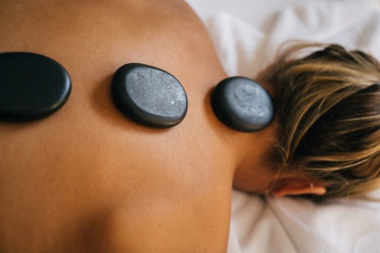 Hot Stone Massage Treatment Along Woman's Back